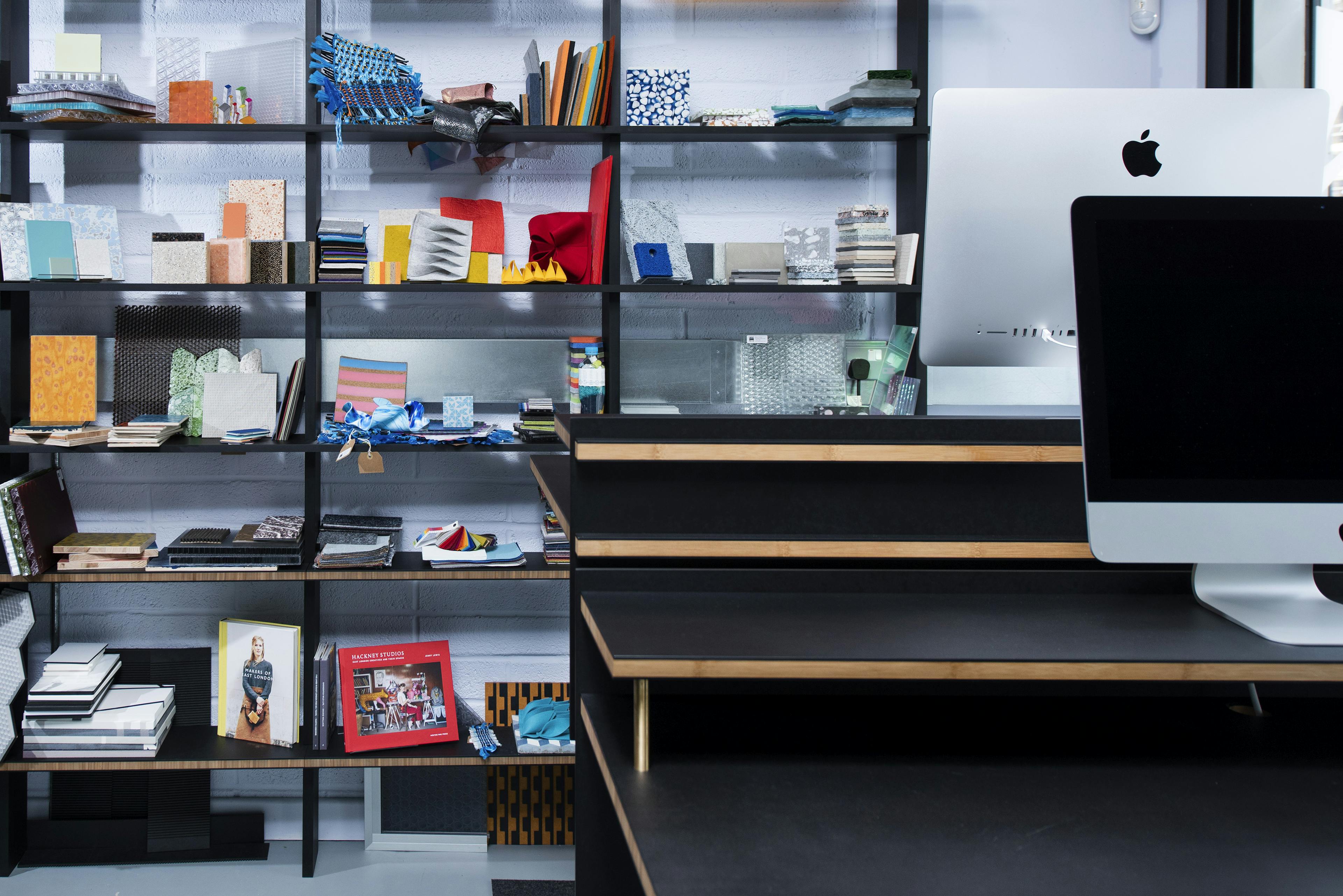 Library shelves and sit stand desks in an inspiring studio at Surface Matter