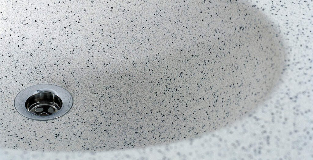 Durat basin oval II sink with a terrazzo look showing off its recycled black solid surface speckles